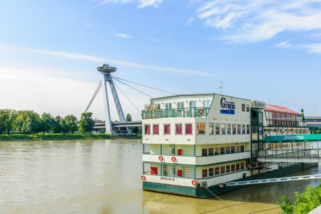 BRATISLAVA, SLOVAKIA - SEPTEMBER 25, 2013: View of the Danube River and SNP Bridge, with a floating hotel, In Bratislava, Slovakiaのeditorial素材
