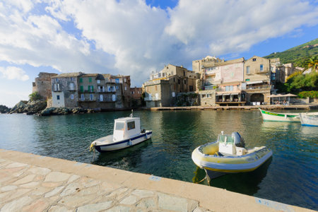 ERBALUNGA, FRANCE - OCTOBER 14, 2014: The village of Erbalunga, with its port, locals and visitors,...