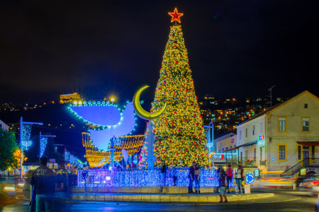 HAIFA, ISRAEL - DECEMBER 13, 2017: The German Colony, decorated for the holidays, with a Christmas tree, Hanukkah Menorah (in Peace Dove form), Muslim Crescent and the Bahai shrine, in Haifa, Israelのeditorial素材