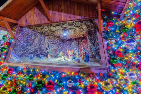 NAZARETH, ISRAEL - DECEMBER 16, 2017: Nativity scene inside a Christmas tree in Mary Well square, in Nazareth, Israelのeditorial素材