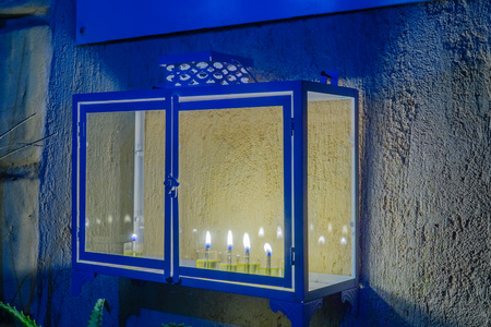 Traditional Menorah (Hanukkah Lamp) with olive oil candles, placed near the door, in the Jewish quarter, in Safed (Tzfat), Israelの写真素材