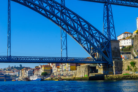 PORTO, PORTUGAL - DECEMBER 24, 2017: View of the Dom Luis I Bridge, the Douro river and the Ribeira (riverside), with colorful buildings, locals and visitors, in Porto, Portugalのeditorial素材