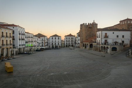 CACERES, SPAIN - DECEMBER 22, 2017: Sunrise scene of the Plaza Mayor (main square), with local businesses, locals and visitors, in Caceres, Extremadura, Spainのeditorial素材