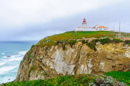 COLARES, PORTUGAL - DECEMBER 28, 2017: View of Cabo (Cape) da Roca, and its lighthouse, with visitors, Portugal. It is the westernmost point in mainland Europeのeditorial素材
