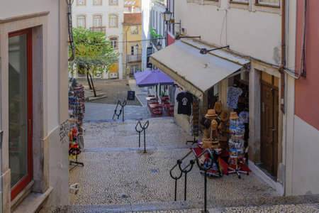 COIMBRA, PORTUGAL - DECEMBER 23, 2017: Old city street with shops, and pedestrians, in Coimbra, Portugalのeditorial素材