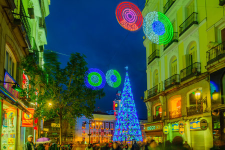 MADRID, SPAIN - DECEMBER 31, 2017: Scene of Puerta del Sol square, with a Christmas tree, locals and visitors, in Madrid, Spainのeditorial素材