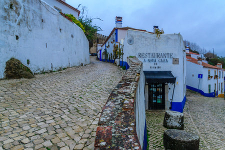 OBIDOS, PORTUGAL - DECEMBER 28, 2017: View of alleys in the old town, with local businesses, in Obidos, Portugalのeditorial素材
