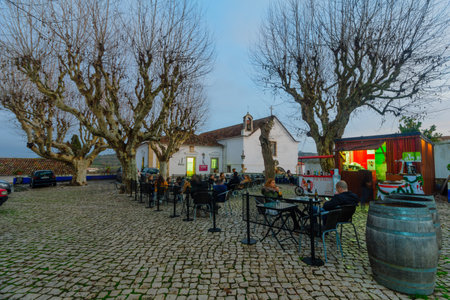 OBIDOS, PORTUGAL - DECEMBER 27, 2017: Scene of the old town, with local cafe, locals and visitors, in Obidos, Portugalのeditorial素材