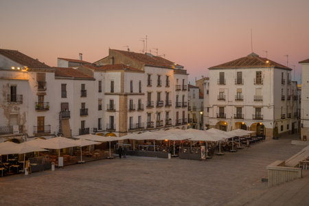 CACERES, SPAIN - DECEMBER 21, 2017: Sunset scene of the Plaza Mayor (main square), with local businesses, locals and visitors, in Caceres, Extremadura, Spainのeditorial素材