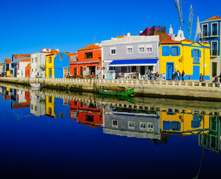 AVEIRO, PORTUGAL - DECEMBER 23, 2017: View of canals, boats, colorful houses, local businesses, locals and visitors, in Aveiro, Portugalのeditorial素材