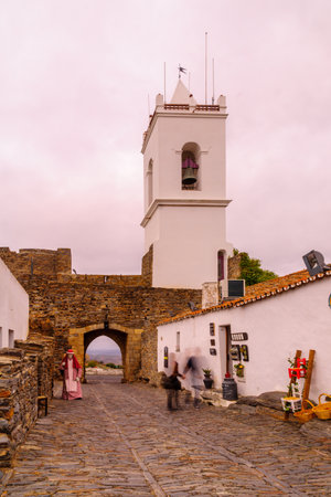 MONSARAZ, PORTUGAL - DECEMBER 29, 2017: Sunset view of the town gate in the historic village, with local businesses and visitors, in Monsaraz, Portugalのeditorial素材
