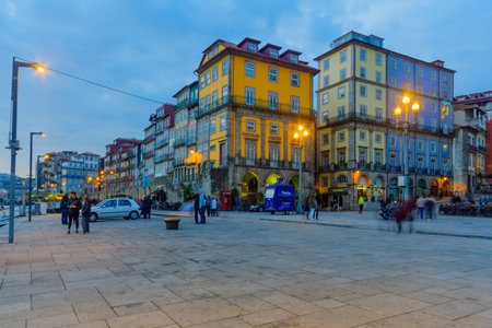 PORTO, PORTUGAL - DECEMBER 24, 2017: Sunset scene of the Ribeira (riverside), with colorful buildings, locals and visitors, in Porto, Portugalのeditorial素材