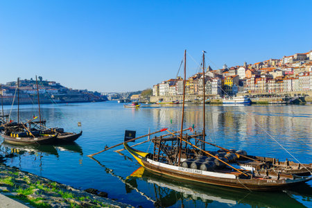 PORTO, PORTUGAL - DECEMBER 24, 2017: View of the Douro river and the Ribeira (riverside), with various boats, colorful buildings, locals and visitors, in Porto, Portugalのeditorial素材