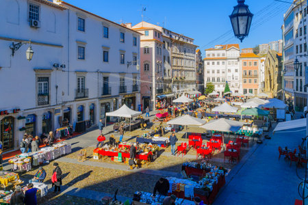 COIMBRA, PORTUGAL - DECEMBER 23, 2017: Flea market scene, with shoppers and sellers, in Coimbra,...