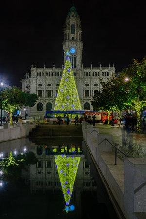 PORTO, PORTUGAL - DECEMBER 24, 2017: Night scene of the Avenida dos Aliados, and the city hall, with a Christmas tree, locals and visitors, in Porto, Portugalのeditorial素材