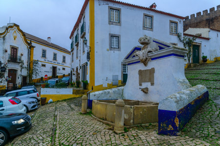OBIDOS, PORTUGAL - DECEMBER 28, 2017: View of alleys in the old town, with local businesses, in Obidos, Portugalのeditorial素材