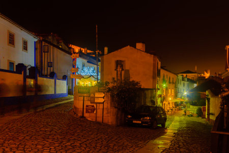 OBIDOS, PORTUGAL - DECEMBER 27, 2017: View of alleys in the old town, with local businesses, and Christmas decorations, in Obidos, Portugalのeditorial素材