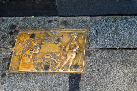 MADRID, SPAIN - DECEMBER 31, 2017: Sign on the street pavement, about history of a local shop, in Madrid, Spainのeditorial素材