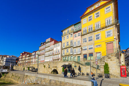 PORTO, PORTUGAL - DECEMBER 24, 2017: Scene of the Ribeira (riverside), with colorful buildings, locals and visitors, in Porto, Portugalのeditorial素材