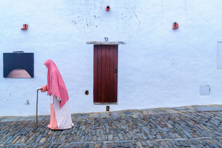 MONSARAZ, PORTUGAL - DECEMBER 30, 2017: Typical house wall and door, and a medieval figure puppet, in the historic village, in Monsaraz, Portugalのeditorial素材