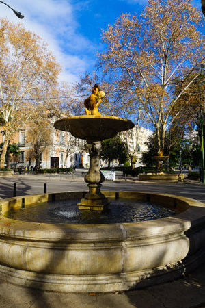 MADRID, SPAIN - JANUARY 1, 2018: View of fountains in Paseo del Prado boulevard, with locals and visitors, in Madrid, Spainのeditorial素材