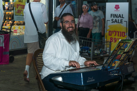 Safed, Israel - August 14, 2018: Scene of the Klezmer Festival, with street musician and crowd, in Safed (Tzfat), Israel. Its the 31st annual traditional Jewish festival in the public streets of Safedのeditorial素材