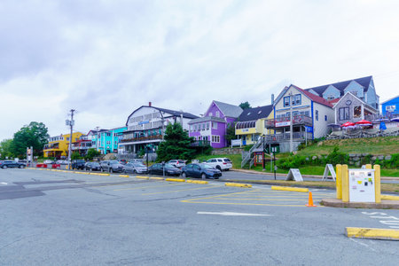 Lunenburg, Canada - September 21, 2018: View of the port and waterfront buildings, with locals and...
