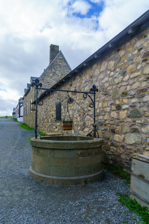 Louisbourg, Canada - September 20, 2018: Water well and historic buildings in the fortress of Louisbourg, Cape Breton island, Nova Scotia, Canadaのeditorial素材