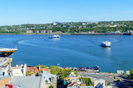 Quebec City, Canada - September 27, 2018: View of ferry traffic in the Saint Lawrence River, with locals and visitors, Quebec City, Quebec, Canadaのeditorial素材