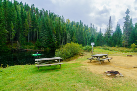 Lac-des-Dix-Milles, Canada - September 28, 2018: View of the Diable (Devil) River, with tourist in a kayak, in Mont Tremblant National Park, Quebec, Canadaのeditorial素材