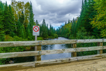 View of the Diable (Devil) River, with warning sign about diving, in Mont Tremblant National Park, Quebec, Canadaの写真素材