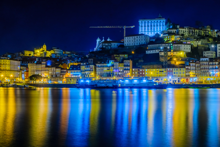 Night view of the Douro river and the Ribeira (riverside), with colorful buildings, in Porto, Portugalの写真素材