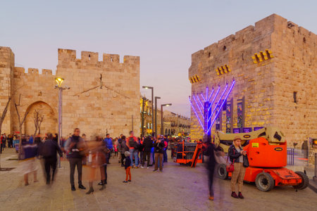 Jerusalem, Israel - December 09, 2018: Sunset scene of the Jaffa gate in the old city walls, with decorations for Hanukkah and Christmas, locals and visitors, in Jerusalem, Israelのeditorial素材