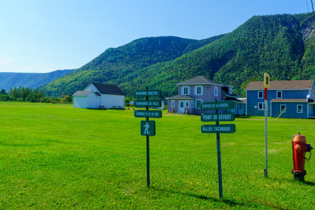Mont-Saint-Pierre, Canada - September 13, 2018: Typical wooden houses and trail directional signs in Mont-Saint-Pierre, Gaspe Peninsula, Quebec, Canadaのeditorial素材