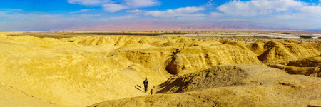 Hazeva, Israel - January 19, 2019: Panoramic Landscape of lissan marl rocks, the Edom mountains, and visitors hiking, along the Arava Peace Road, Southern Israelのeditorial素材
