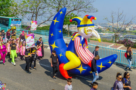 Nesher, Israel - March 22, 2019: People, some in costumes, celebrate the Jewish holyday of Purim in the Adloyada parade, in Nesher, Israelのeditorial素材
