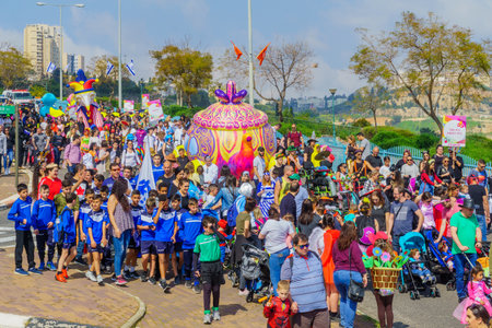 Nesher, Israel - March 22, 2019: People, some in costumes, celebrate the Jewish holyday of Purim in the Adloyada parade, in Nesher, Israelのeditorial素材