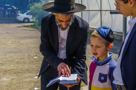 Haifa, Israel - April 19, 2019: Jewish man read a blessing, part of a Biur (burning) Chametz...