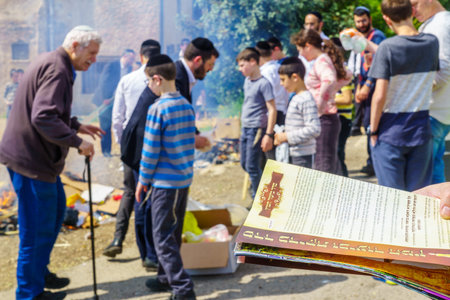 Haifa, Israel - April 19, 2019: Jewish man read a blessing, part of a Biur (burning) Chametz...