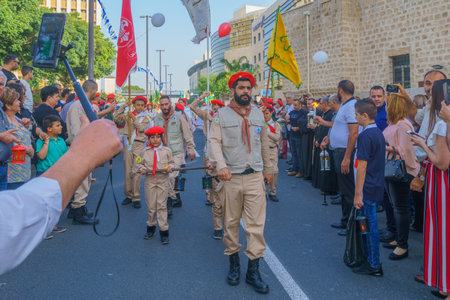 Haifa, Israel - April 27, 2019: Scouts perform a Holy Saturday parade, and crowd attend and document, part of Orthodox Easter celebration in Haifa, Israelのeditorial素材