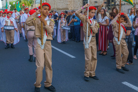 Haifa, Israel - April 27, 2019: Scouts perform a Holy Saturday parade, carrying the holy fire, and...
