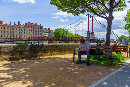 Lyon, France - May 10, 2019: The Saone River, and Saint-Gorges bridge, with locals and visitors, in Old Lyon, Franceのeditorial素材