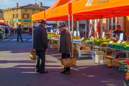 Le-Bois-de-Oingt, France - May 07, 2019: French market scene with sellers and shoppers in Le-Bois-de-Oingt, Beaujolais, Rhone department, Franceのeditorial素材