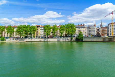 Lyon, France - May 10, 2019: The Saone River, colorful houses, with locals and visitors, in Lyon, Franceのeditorial素材