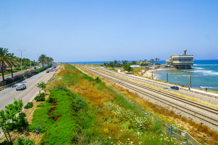Haifa, Israel - May 18, 2019: View the coast, with railway and the Oceanographic center, with locals, in Haifa, Israelのeditorial素材