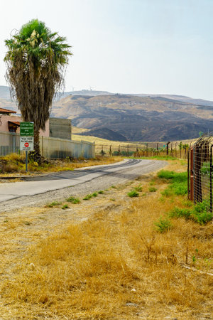 Gesher, Israel - June 04, 2019: The Jordan River valley, and border warning signs, near the border between Israel and Jordanのeditorial素材