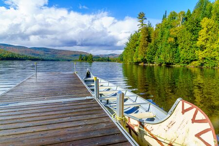 View of pier and boat in Monroe Lake, in Mont Tremblant National Park, Quebec, Canada