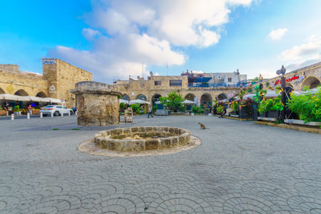 Acre, Israel - July 08, 2019: Scene of the historic Khan a-Shawarda, with local businesses, locals and visitors, in the old city of Acre (Akko), Israelのeditorial素材