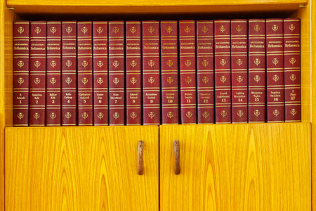 Haifa, Israel = August 14, 2019: Volumes 1 - 17 of the Encyclopedia Britannica, 1965 edition, on a wooden bookshelfのeditorial素材