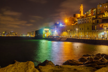 Tel-Aviv, Israel - September 19, 2019: Night scene of the historic Jaffa port, with Saint Peter Church tower, Tel-Aviv skyline, locals and visitors. Now part of Tel-Aviv-Yafo, Israelのeditorial素材